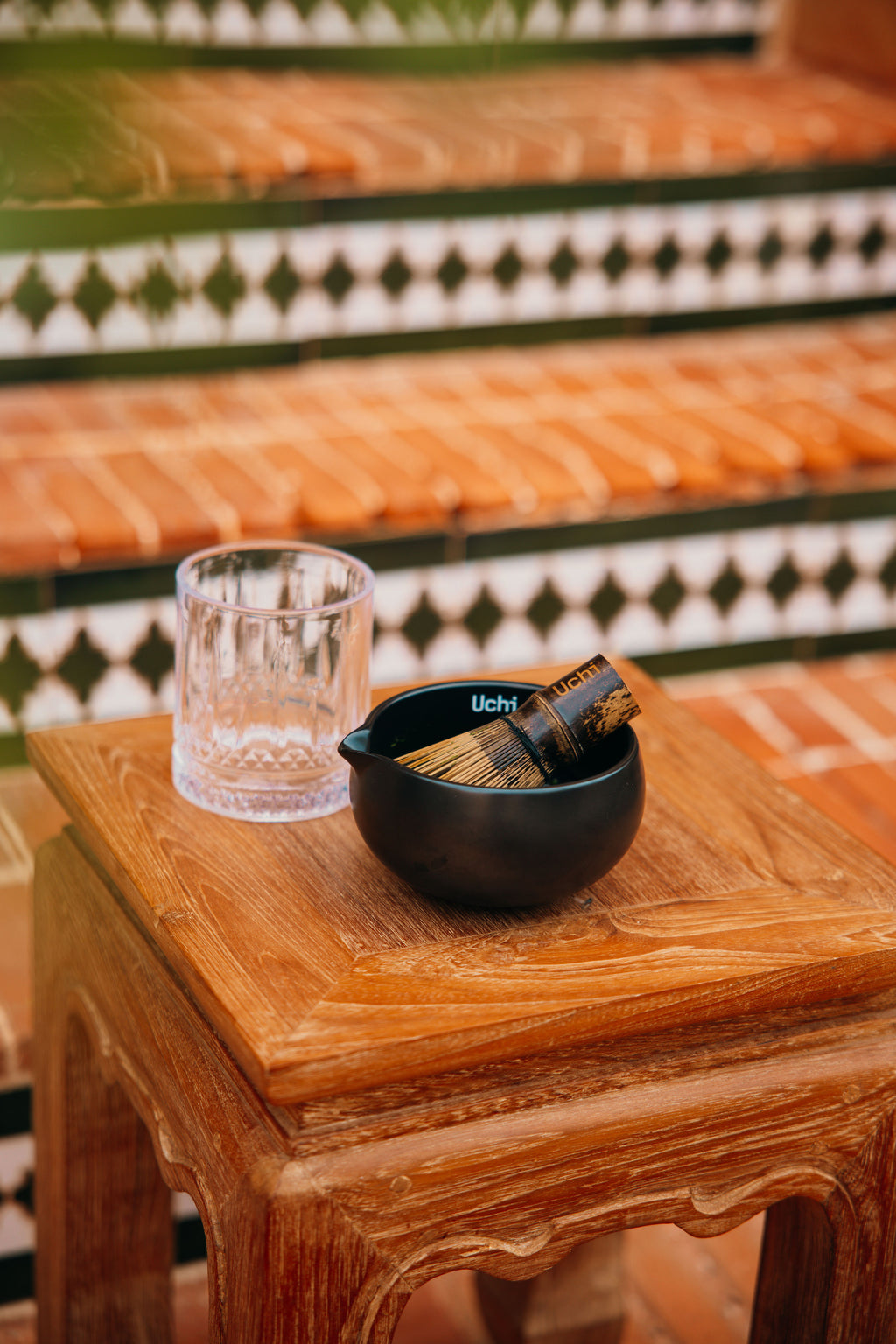 Uchi Bowl with prepared matcha, side view, wooden matcha chasen or whisk