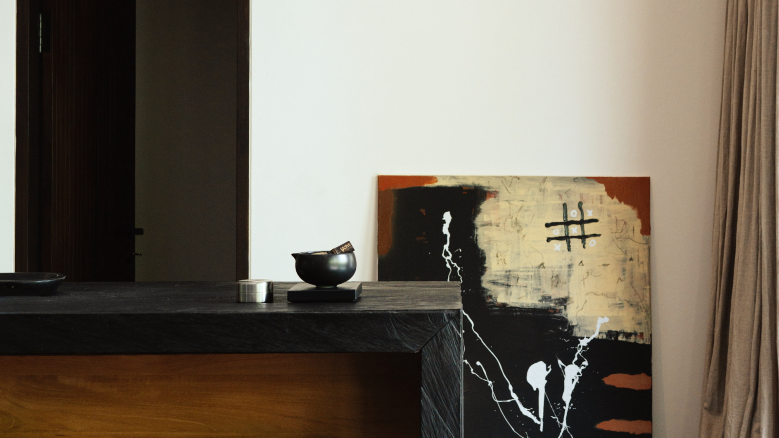 Uchi home with essentials next to a Abstract painting on a wall