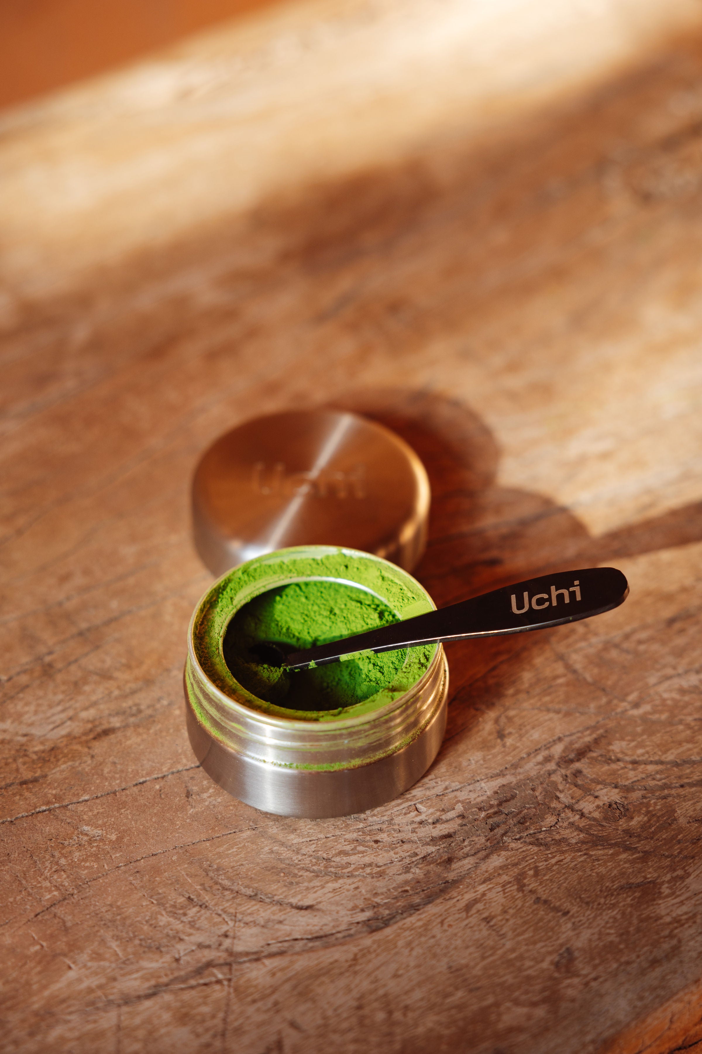  Uchi Pod close-up showing matcha inside. Matcha refill pod containing 40g of ceremonial grade matcha. Matcha measuring spoon